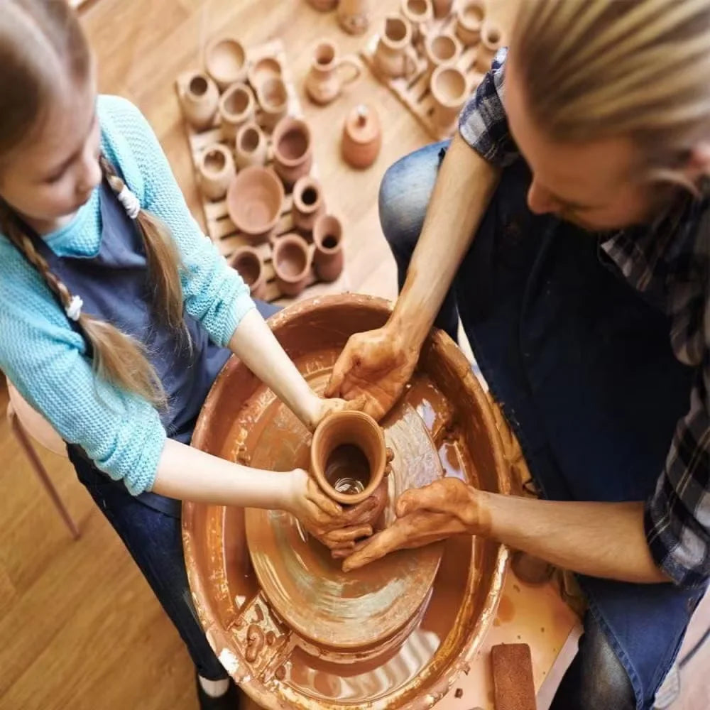 Two people are using a round sponge brush set for painting or crafting on a wooden surface.