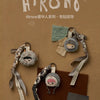 A blind box keychain featuring the Hirono Mist-Walker character, made of fabric and attached to a strap.