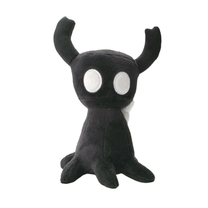 A black plush doll resembling a small creature with white eyes and horns.