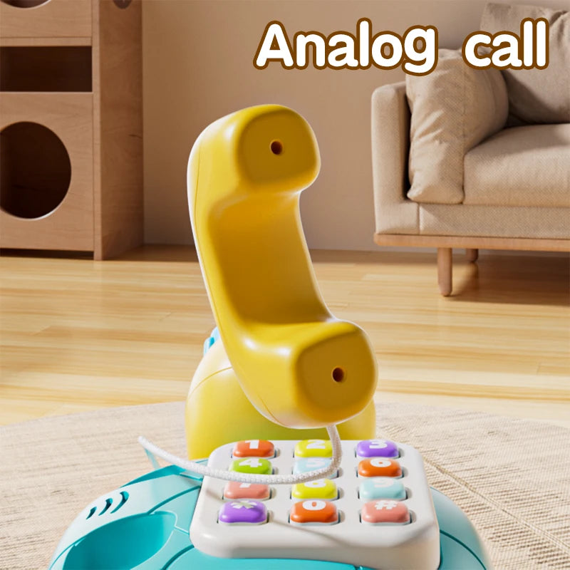 A yellow musical crawling turtle toy is shown with a phone function on a light blue base.