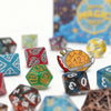 A collection of colorful dice, including festive and holiday-themed dice, scattered on a white surface.