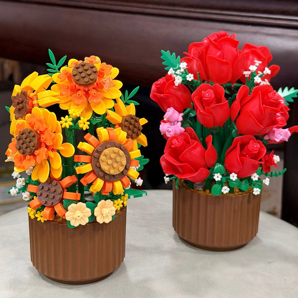 A bouquet of red roses and yellow sunflowers made from building blocks in a brown pot.