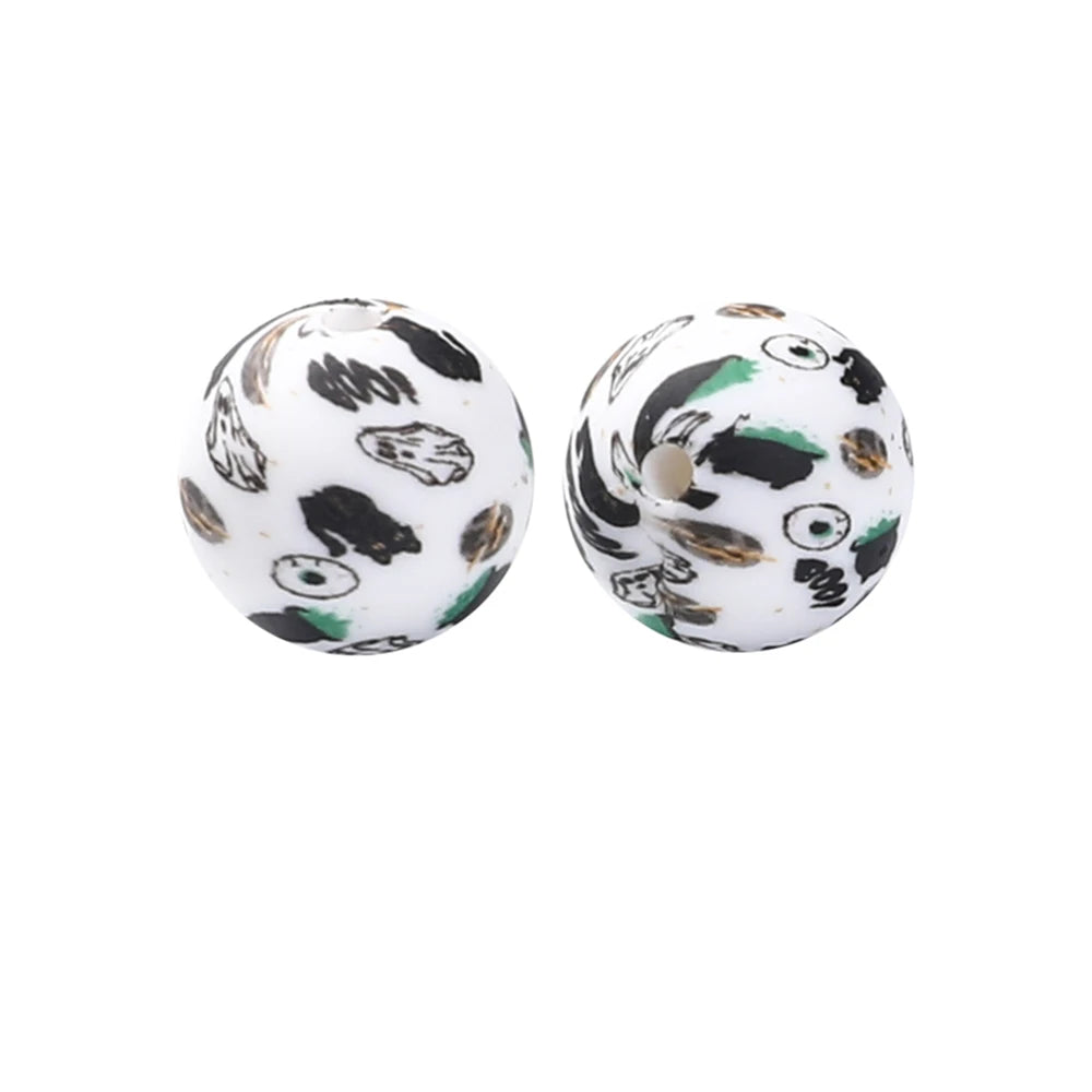 A pair of round silicone beads with a black and white leopard print design for jewelry making