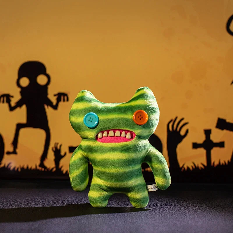 A bright green plush monster doll with large teeth and orange eyes is displayed against a dark background.