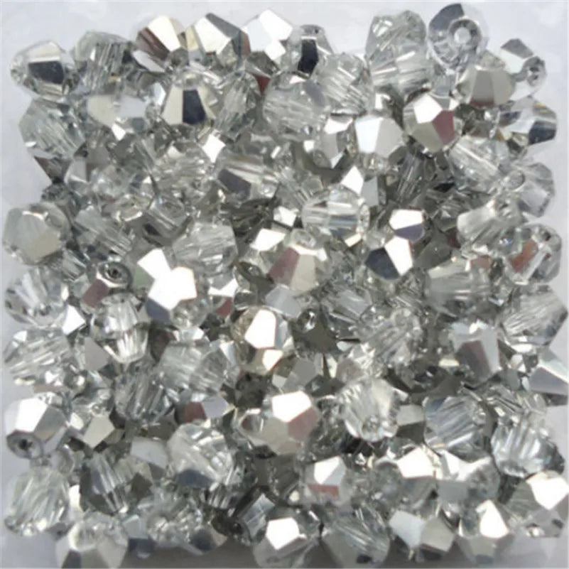 A pile of clear faceted glass bicone beads for jewelry making