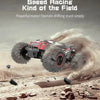 A red and black 1:18 scale 4WD off-road RC monster truck driving through dirt and dust.