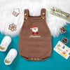 A brown knit baby romper with a red Santa embroidery and Christmas theme displayed on a white fluffy background.