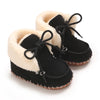 A pair of black plush baby snow boots with light fur trim and anti-slip soles.