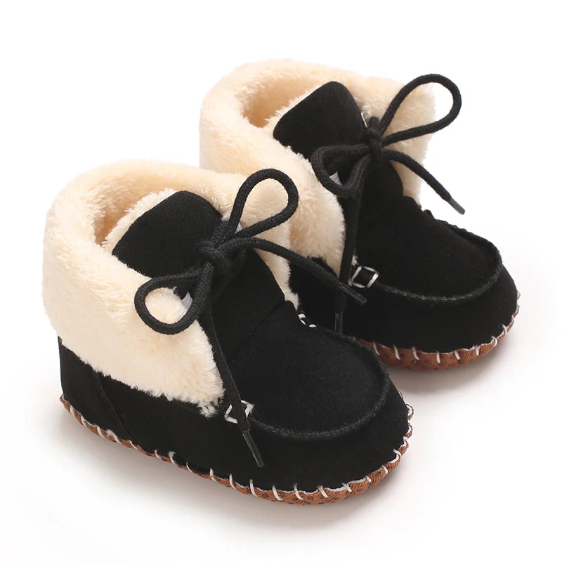 A pair of black plush baby snow boots with light fur trim and anti-slip soles.