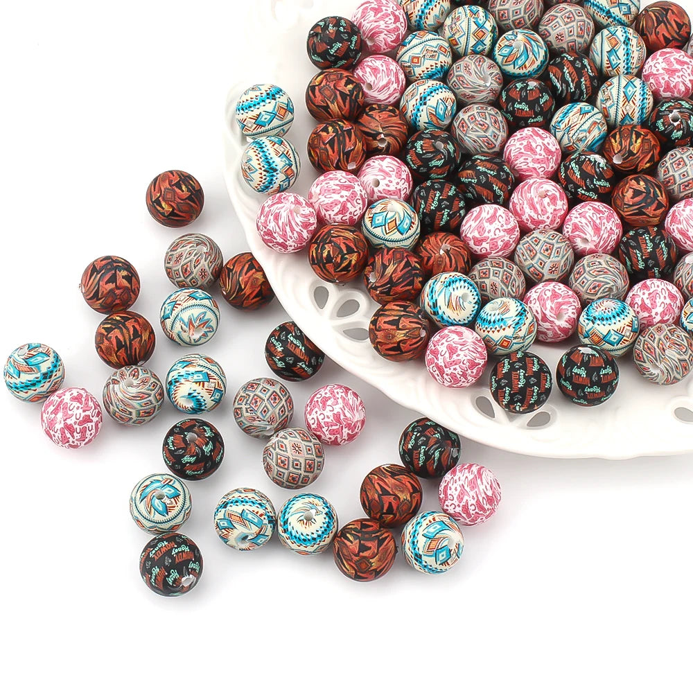A collection of colorful printed silicone beads in various patterns and colors arranged on a white dish.