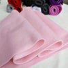 Pink felt fabric sheets rolled up next to various colored felt rolls for DIY crafts