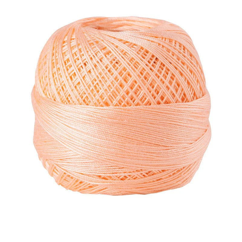 A ball of light peach colored 100% cotton crochet thread for tatting and embroidery.