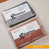 Packaged block of red stone clay with the OUMMAA logo and product information
