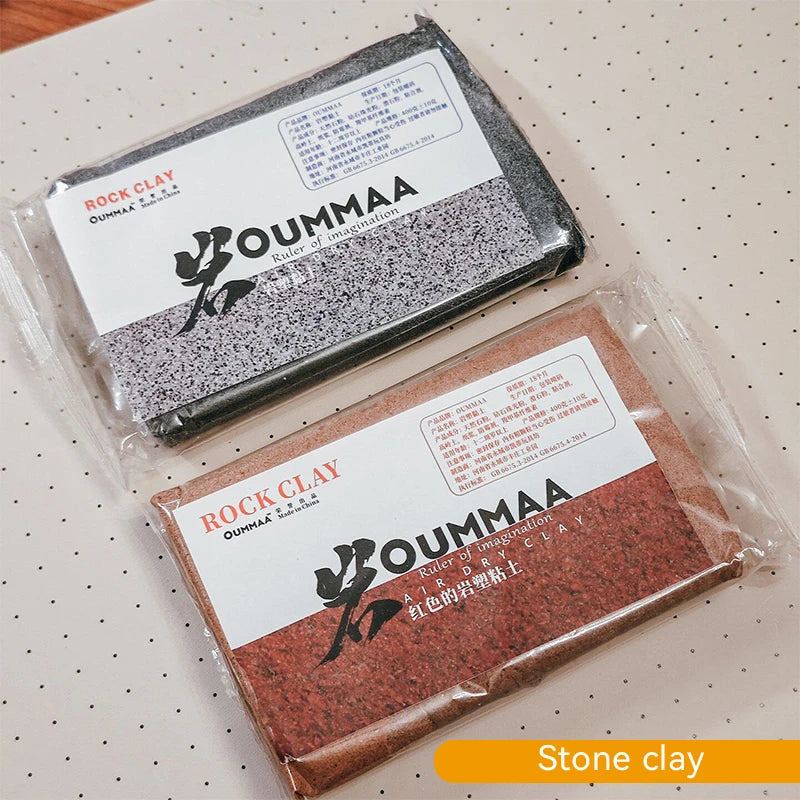 Packaged block of red stone clay with the OUMMAA logo and product information