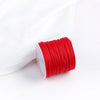 A roll of bright red 0.8mm cotton nylon macrame cord for jewelry making and crafts.