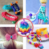 A collection of glow-in-the-dark loom band bracelets and a pink hair bow, showing various colors and crafting materials.