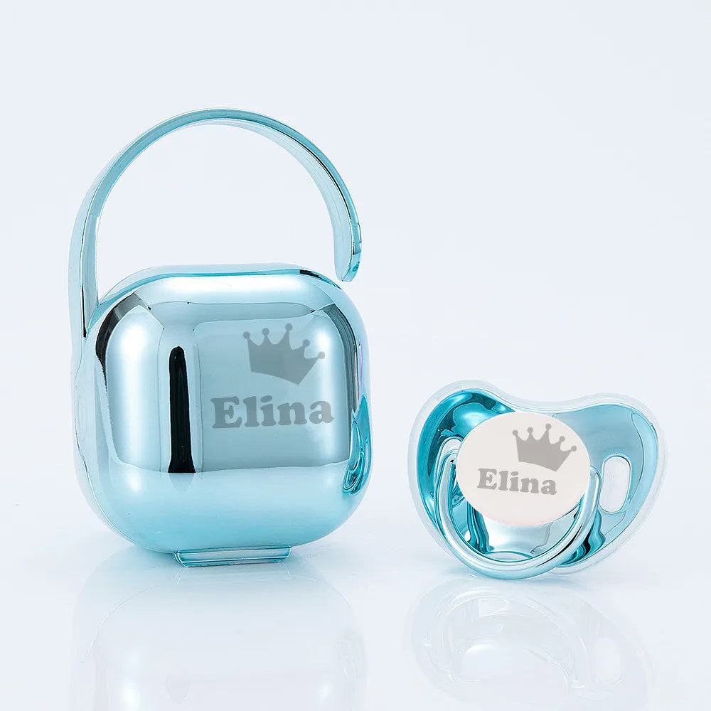 A shiny blue pacifier storage case with a crown design and an Elina label.