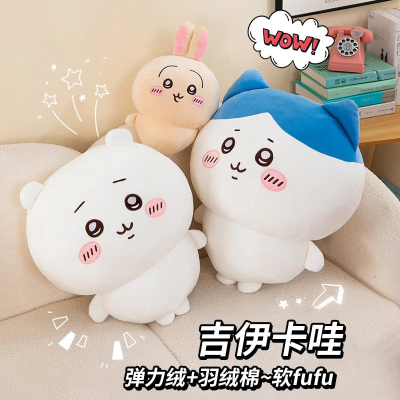 A set of Chiikawa Hachiware and Usagi plush dolls, soft white and blue, sitting on a light-colored sofa.