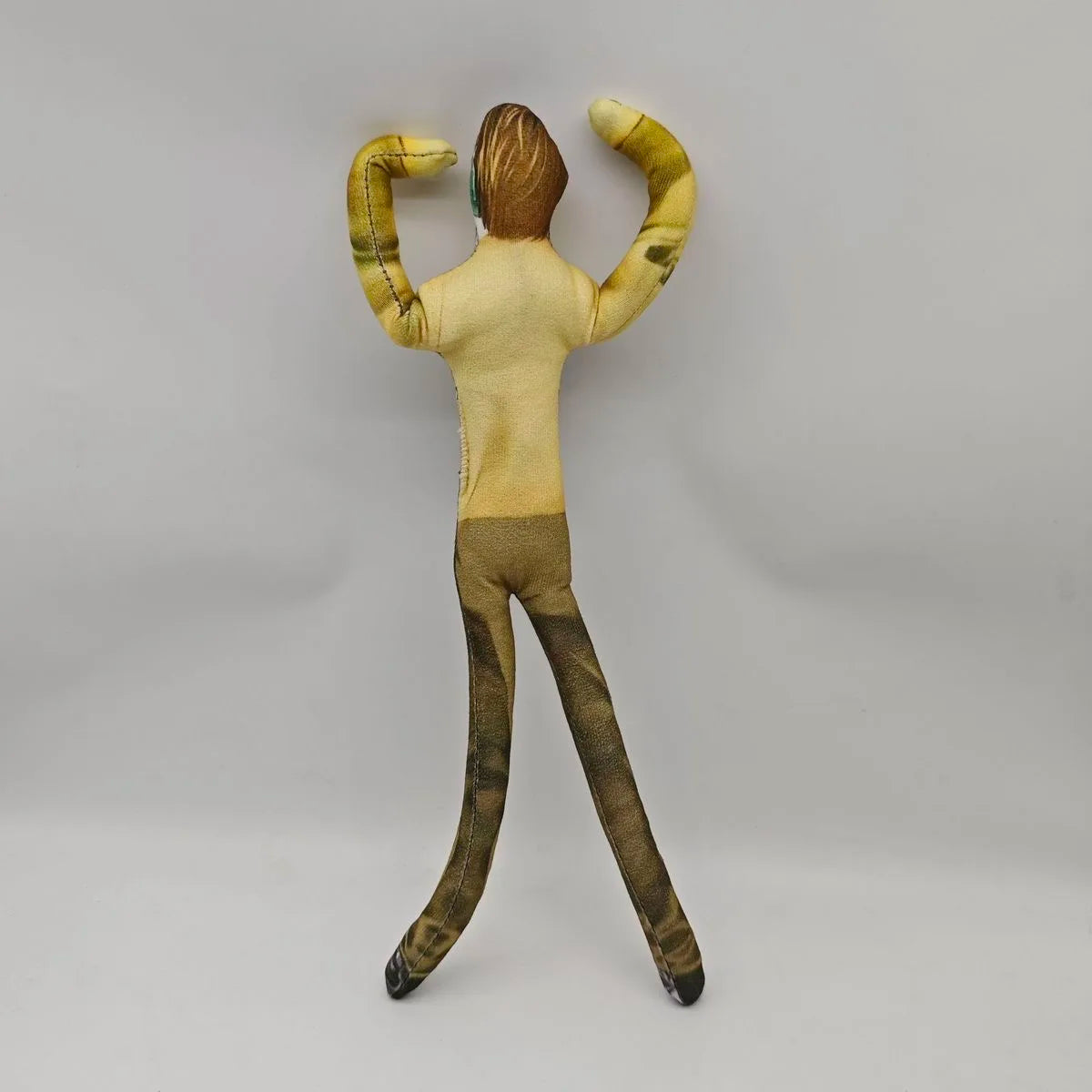 A plush doll resembling L Lawliet from Death Note, standing and posing with arms raised.