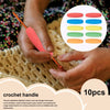 A hand is using a peach-colored crochet handle to manipulate colorful foam grip sleeves for tools and utensils.