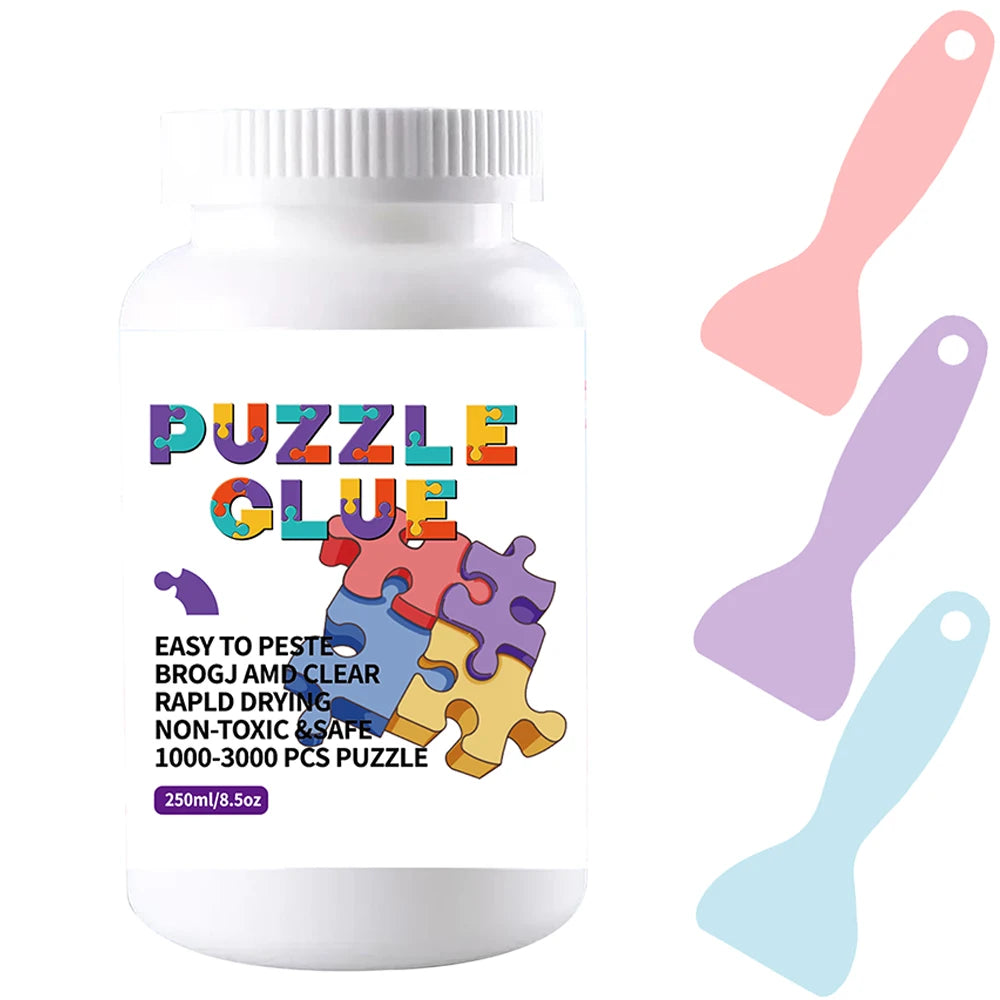 A white bottle of Puzzle Glue with a purple and orange label and a pink plastic spatula next to it.