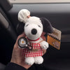 A white dog plush toy resembling Snoopy with a red collar and a tennis racket charm