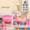 A collection of doctor toys including a pink first aid kit, various medical accessories, and play sets for children.