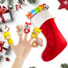 A hand holds a red Christmas stocking filled with ten soft rubber animal finger puppets for kids.