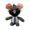 A plush toy of a black and gray creature with large pink ears and a blue belly button detail.