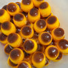 A pile of yellow and brown squishy pudding stress balls or fidget toys