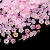 A pile of pink and purple gradient acrylic bellflower beads for jewelry making