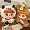 A plush collectible doll featuring a white body and brown accents, displayed next to a brown furry animal figure.
