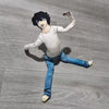A poseable plush doll resembling L Lawliet from Death Note, dressed in a white shirt and blue jeans.