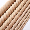 A close-up of vintage wood carved applique pieces arranged in parallel rows.