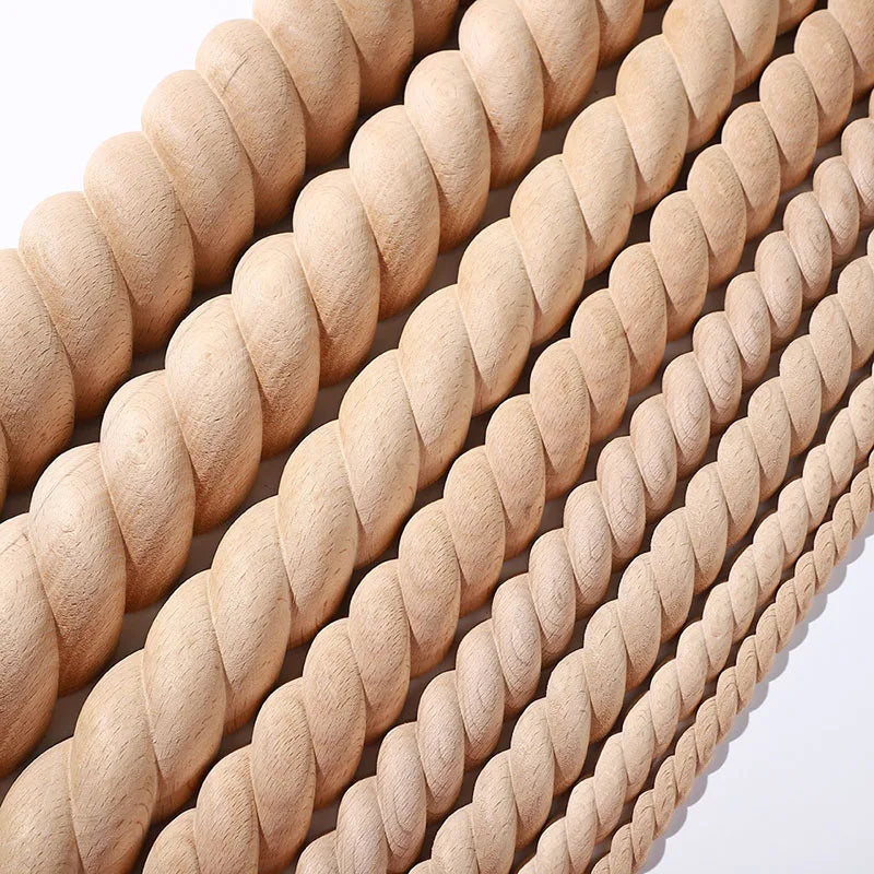 A close-up of vintage wood carved applique pieces arranged in parallel rows.