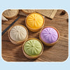A collection of colorful, squishy bear-shaped stress relief fidget toys in various pastel shades arranged on a wooden surface