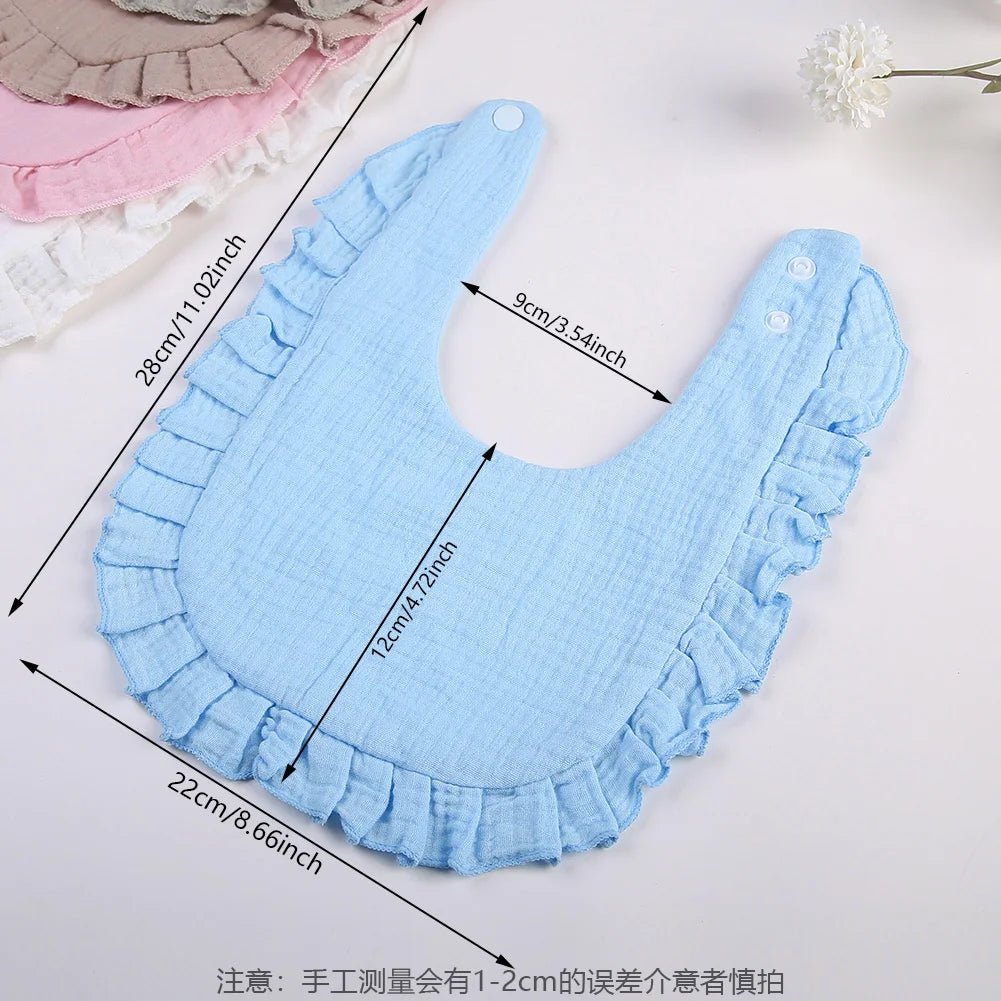 Light blue ruffled muslin cotton baby bib with adjustable snap closure