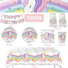 A collection of unicorn party supplies including decorations, tableware, and a tablecloth for a birthday celebration.