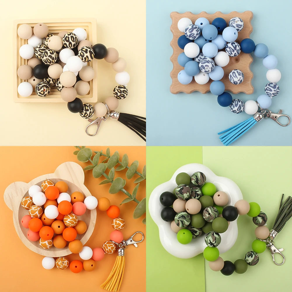 A collection of printed silicone beads in leopard and daisy patterns for jewelry making, displayed on wooden trays.