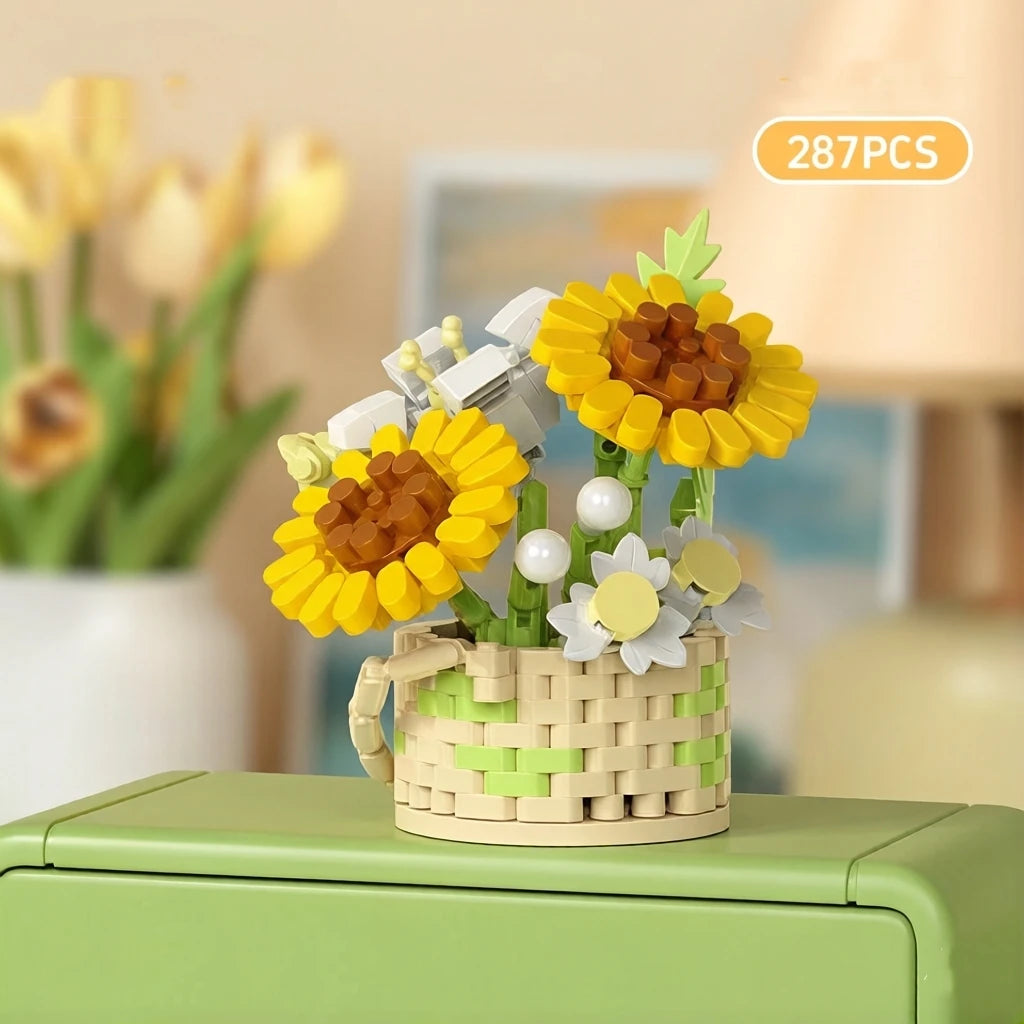 A yellow flower basket made of wooden building blocks with white and yellow flowers on a green surface.