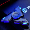 A close-up of a blue metal luminous fidget spinner with a hexagonal design resting on a dark surface.