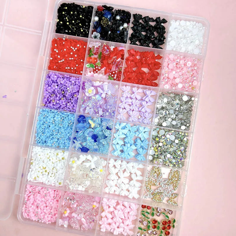 A clear plastic tray filled with various colorful DIY nail art charms including bows, flowers, fruits, and butterflies.