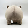 A beige Moo Deng Pygmy Hippo plush toy with small ears, shown from the back.