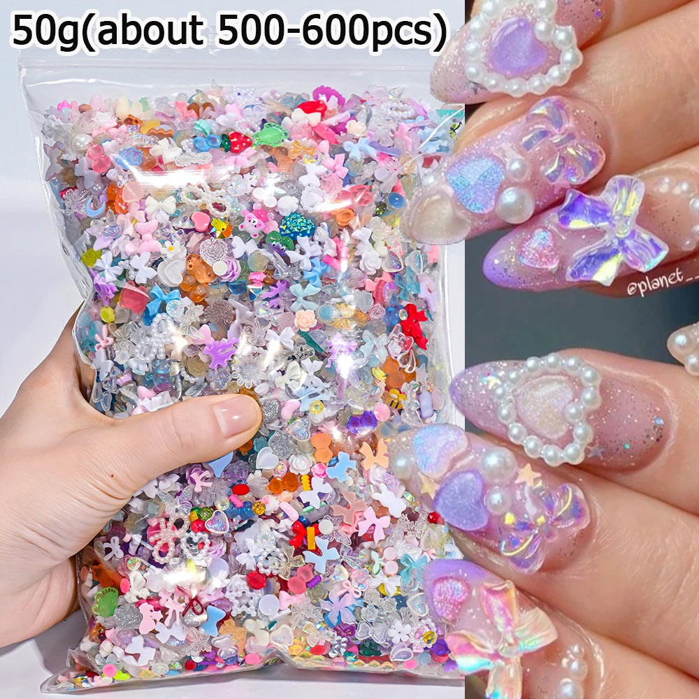 A hand holds a small plastic bag filled with 50 grams of multicolor resin nail charms for crafting.