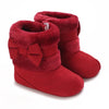 A pair of red faux fur baby winter boots for first walkers.