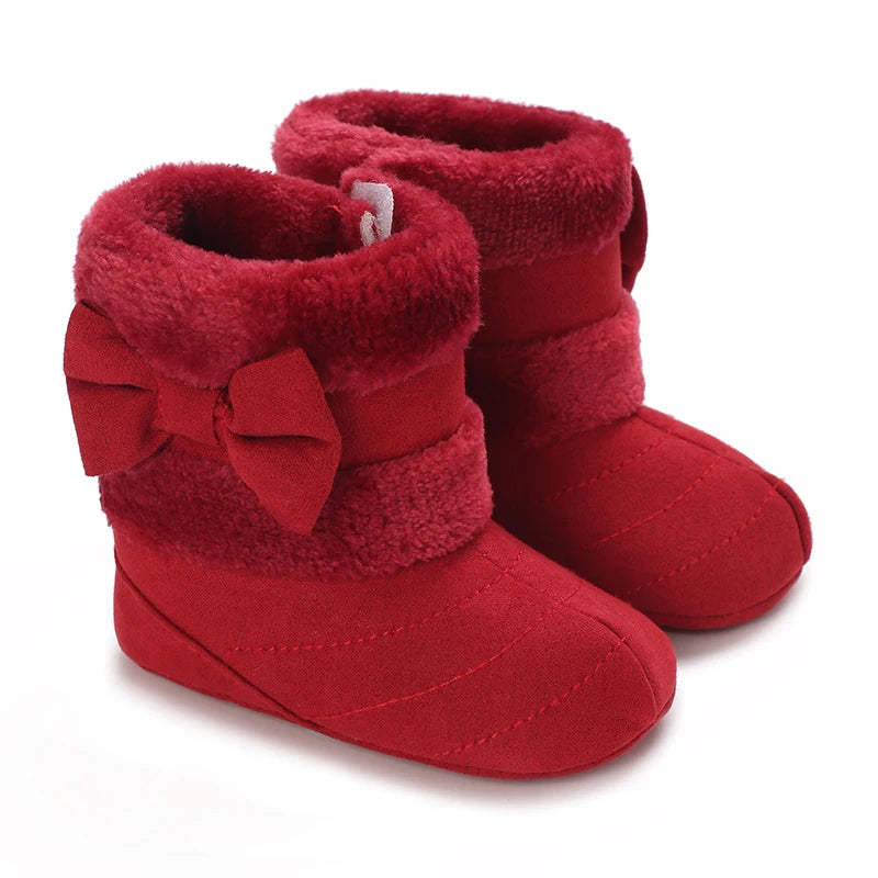 A pair of red faux fur baby winter boots for first walkers.