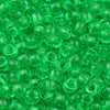 A close-up view of small, translucent green pony beads for jewelry making and crafts.