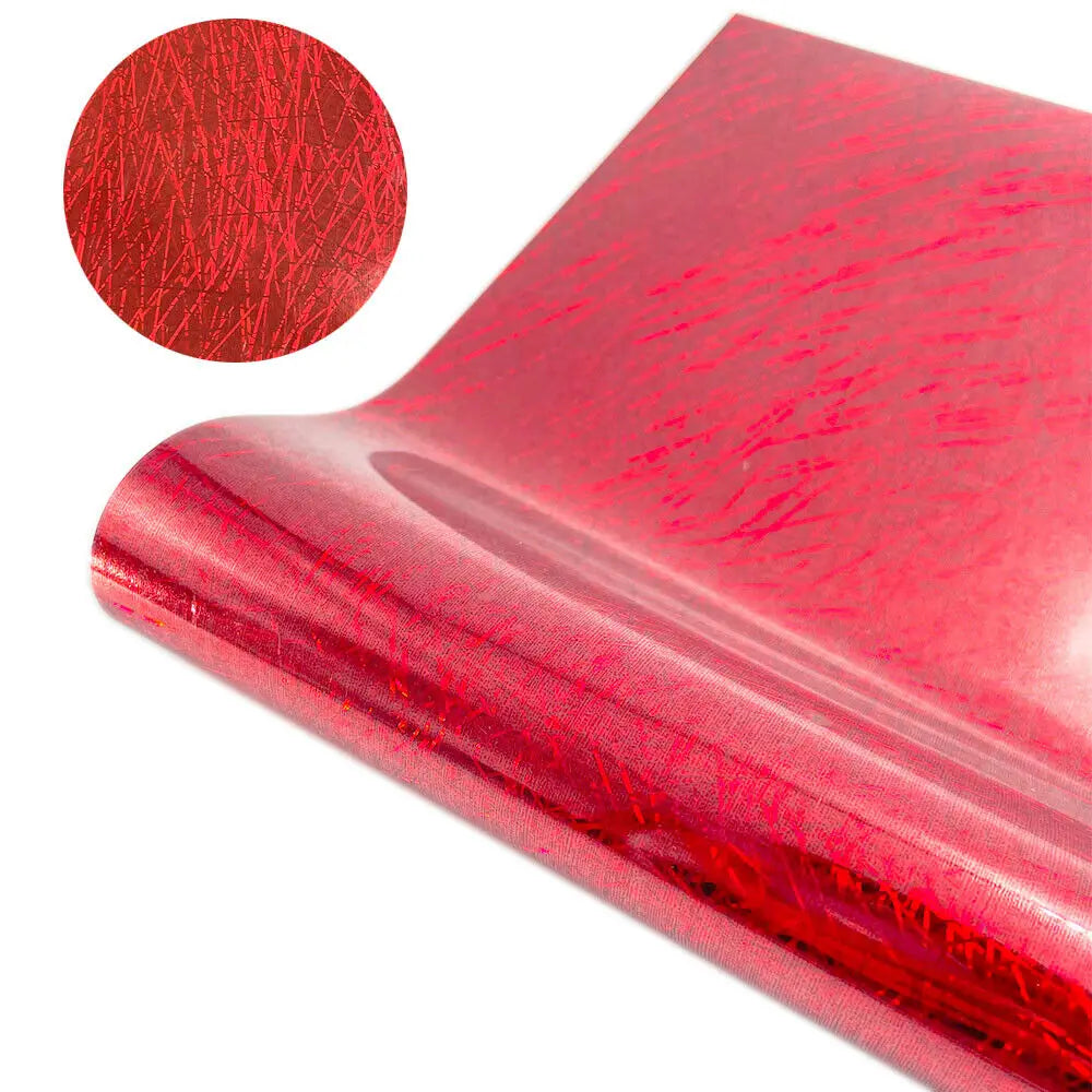 A close-up of red glitter holographic heat transfer vinyl material, showing its texture and sheen.