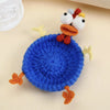 Handmade crochet lizard coaster featuring a blue body, orange feet, and white head with yellow accents.