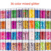 A collection of 36 mixed colored glitter powders in small glass jars for crafting and art projects